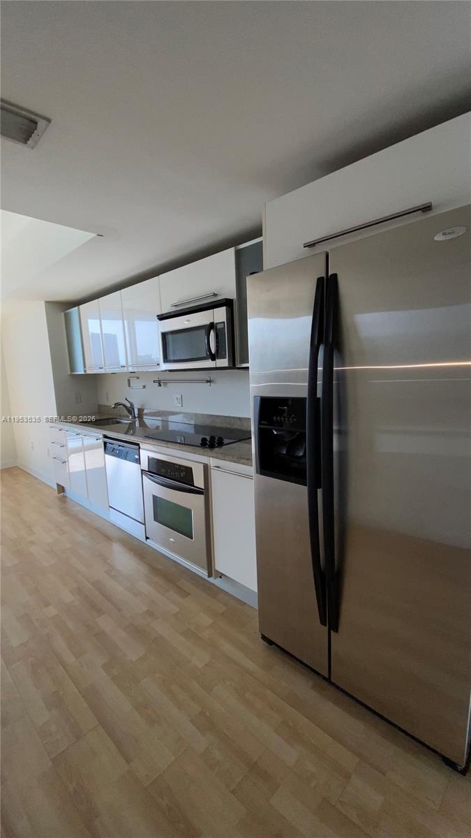185 Southwest 7th Street, Unit 3706 Miami, FL 33130 - Photo 11 of 26 a kitchen with stainless steel appliances a refrigerator and a stove