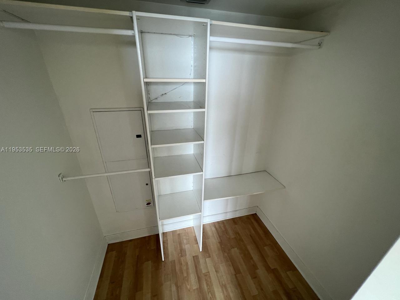 185 Southwest 7th Street, Unit 3706 Miami, FL 33130 - Photo 15 of 26 a view of walk in closet with wooden floor