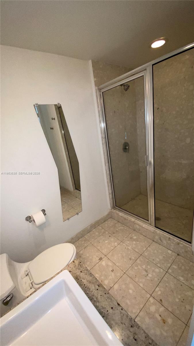 185 Southwest 7th Street, Unit 3706 Miami, FL 33130 - Photo 18 of 26 a bathroom with a sink and a mirror