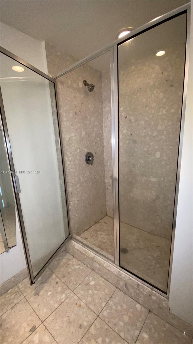 185 Southwest 7th Street, Unit 3706 Miami, FL 33130 - Photo 19 of 26 a bathroom with a glass shower door
