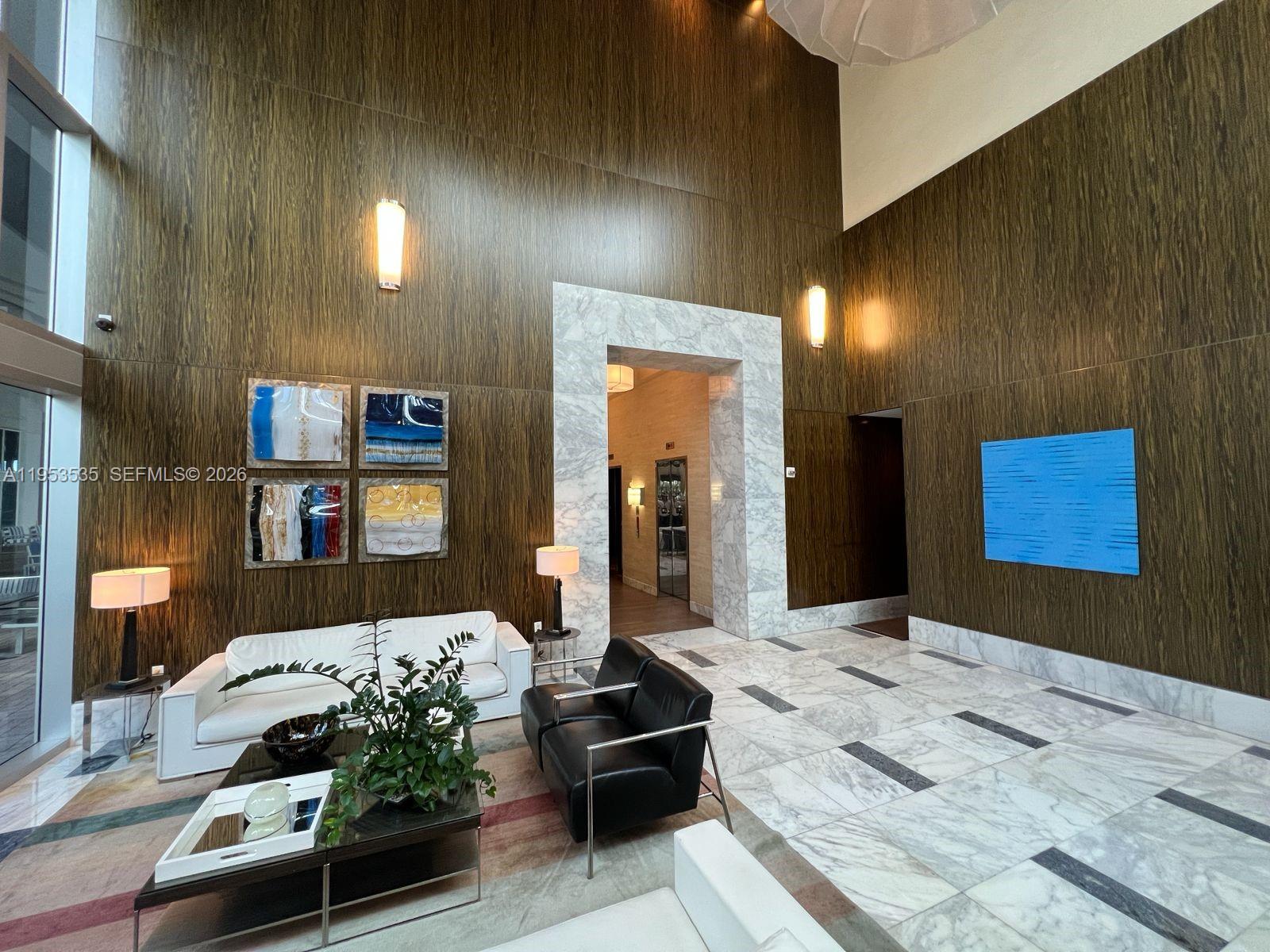 185 Southwest 7th Street, Unit 3706 Miami, FL 33130 - Photo 6 of 26 a bedroom with a bed and a mirror