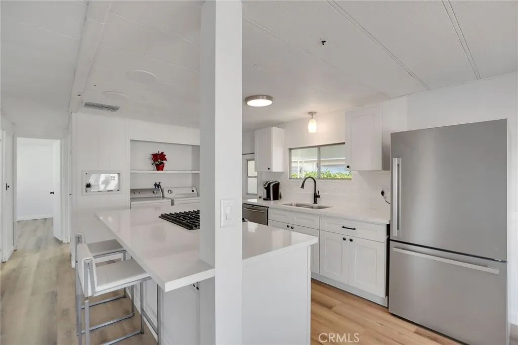 840 Foothill, Unit 27 Azusa, CA 91702 - Photo 14 of 30 a kitchen with stainless steel appliances a refrigerator sink and cabinets