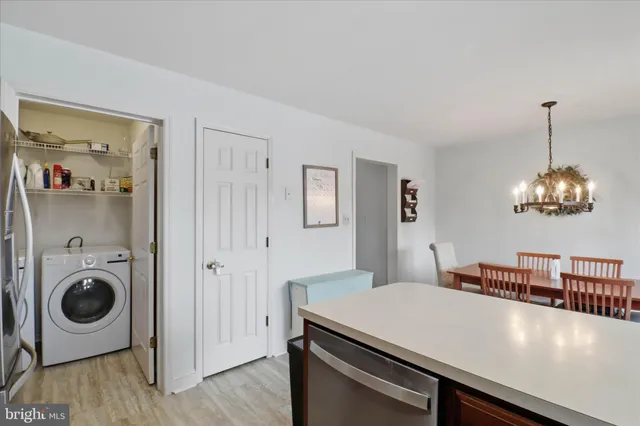 a view of a dining room with a table and chairs