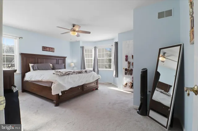 a bedroom with a bed closet and a window