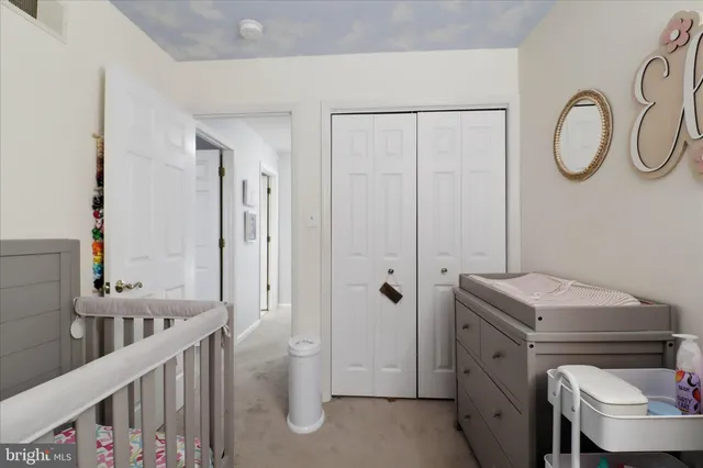 a bathroom with a granite countertop sink a toilet and a mirror