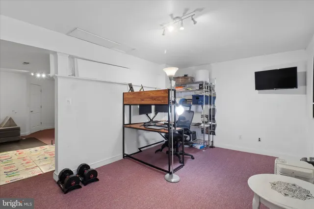 a workspace with furniture and a air conditioner vent