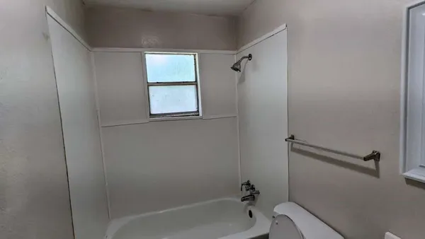 a bath room with a toilet and a bath tub