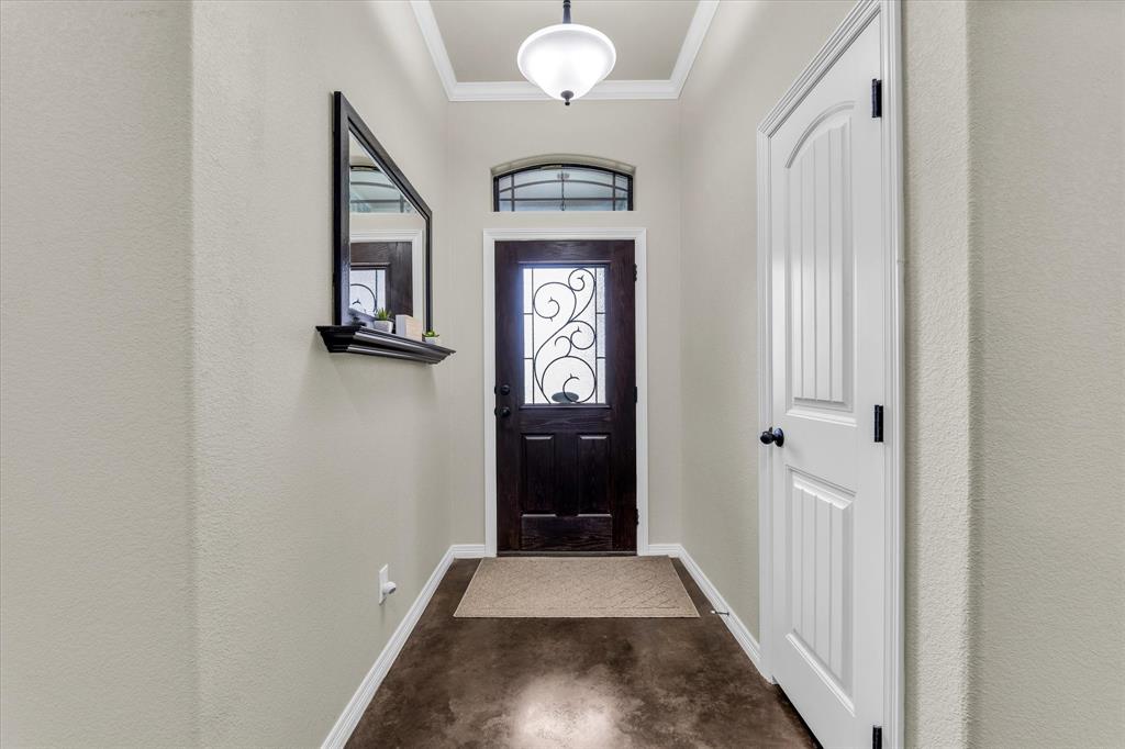 814 Springdale Circle Lorena, TX 76655 - Photo 12 of 37 Entryway featuring a dark wood door with decorative ironwork and an arched transom window