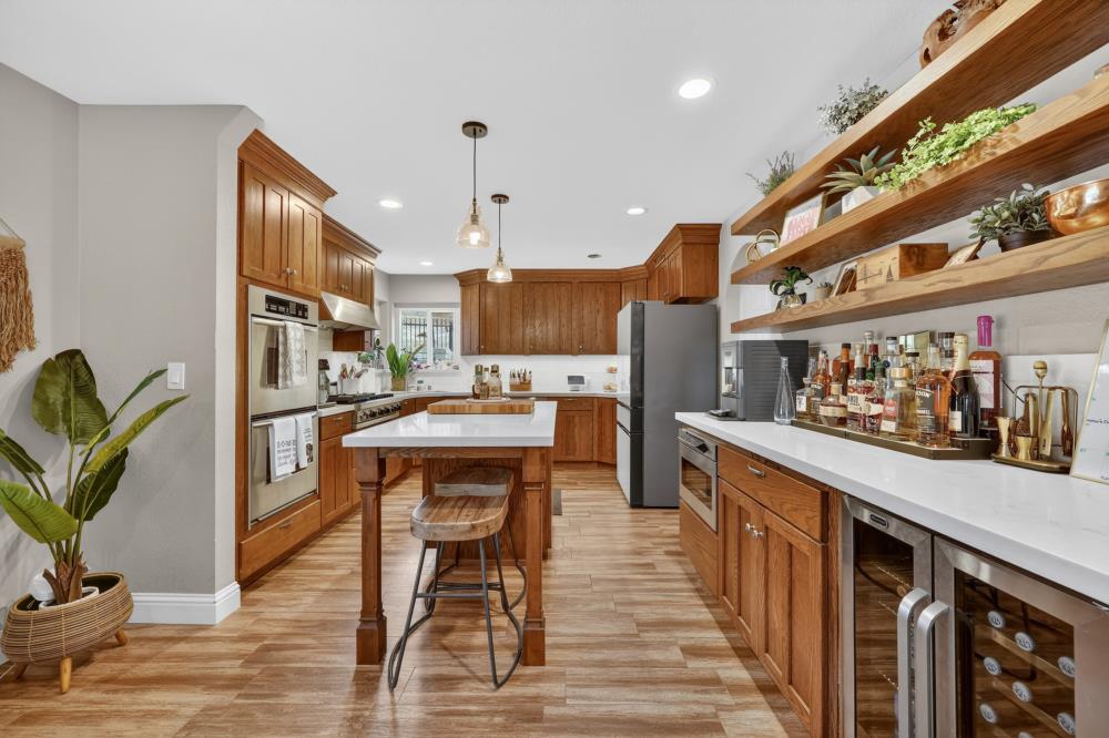 3340 Garden Bar Road Lincoln, CA 95648 - Photo 13 of 56 a kitchen with stainless steel appliances granite countertop sink wooden cabinets and counter top space