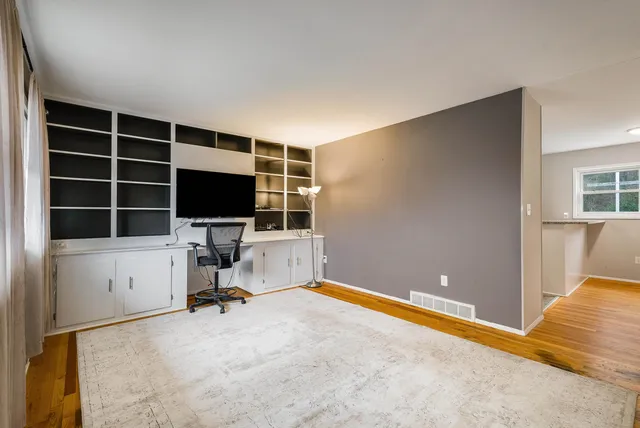a view of a livingroom with furniture and a flat screen tv