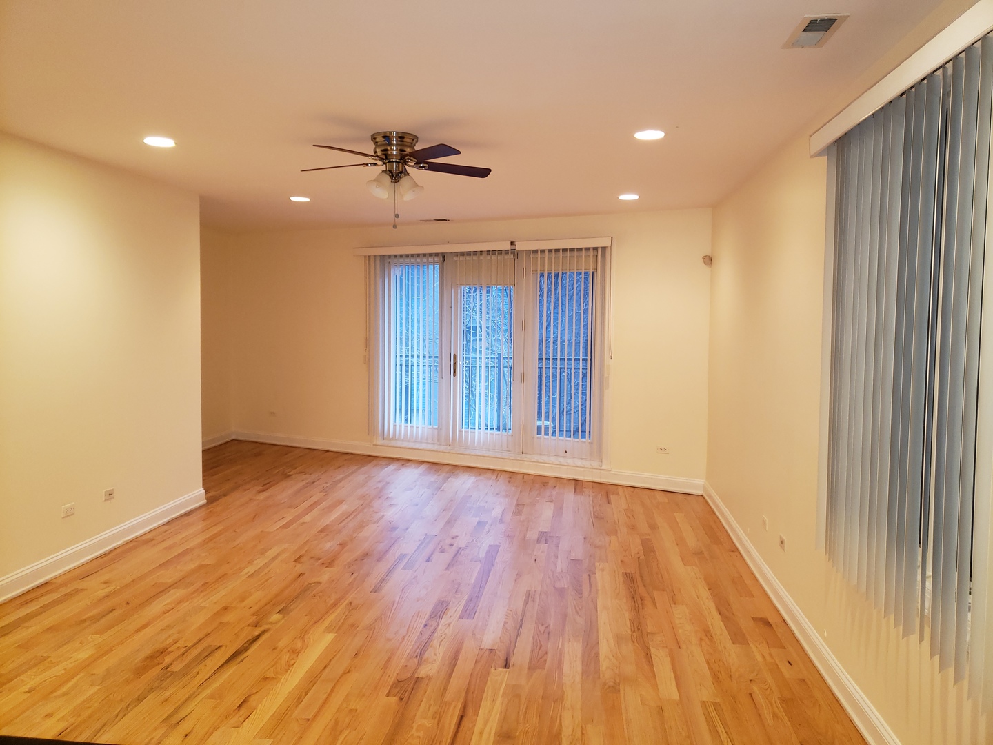 27 East 26th Street, Unit 3 Chicago, IL 60616 - Photo 3 of 17 a view of an empty room with wooden floor and a window