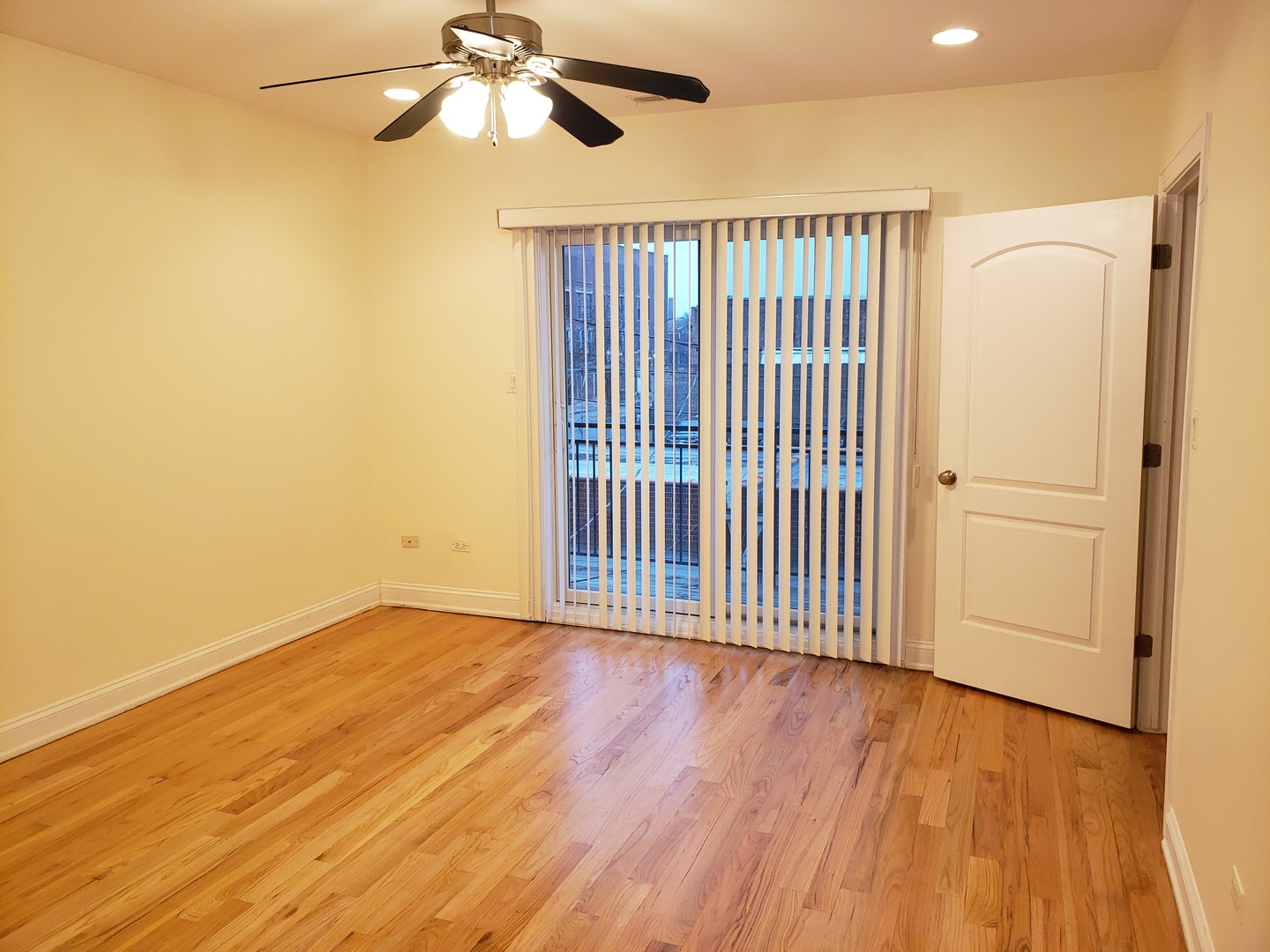 27 East 26th Street, Unit 3 Chicago, IL 60616 - Photo 7 of 17 an empty room with wooden floor fan and windows