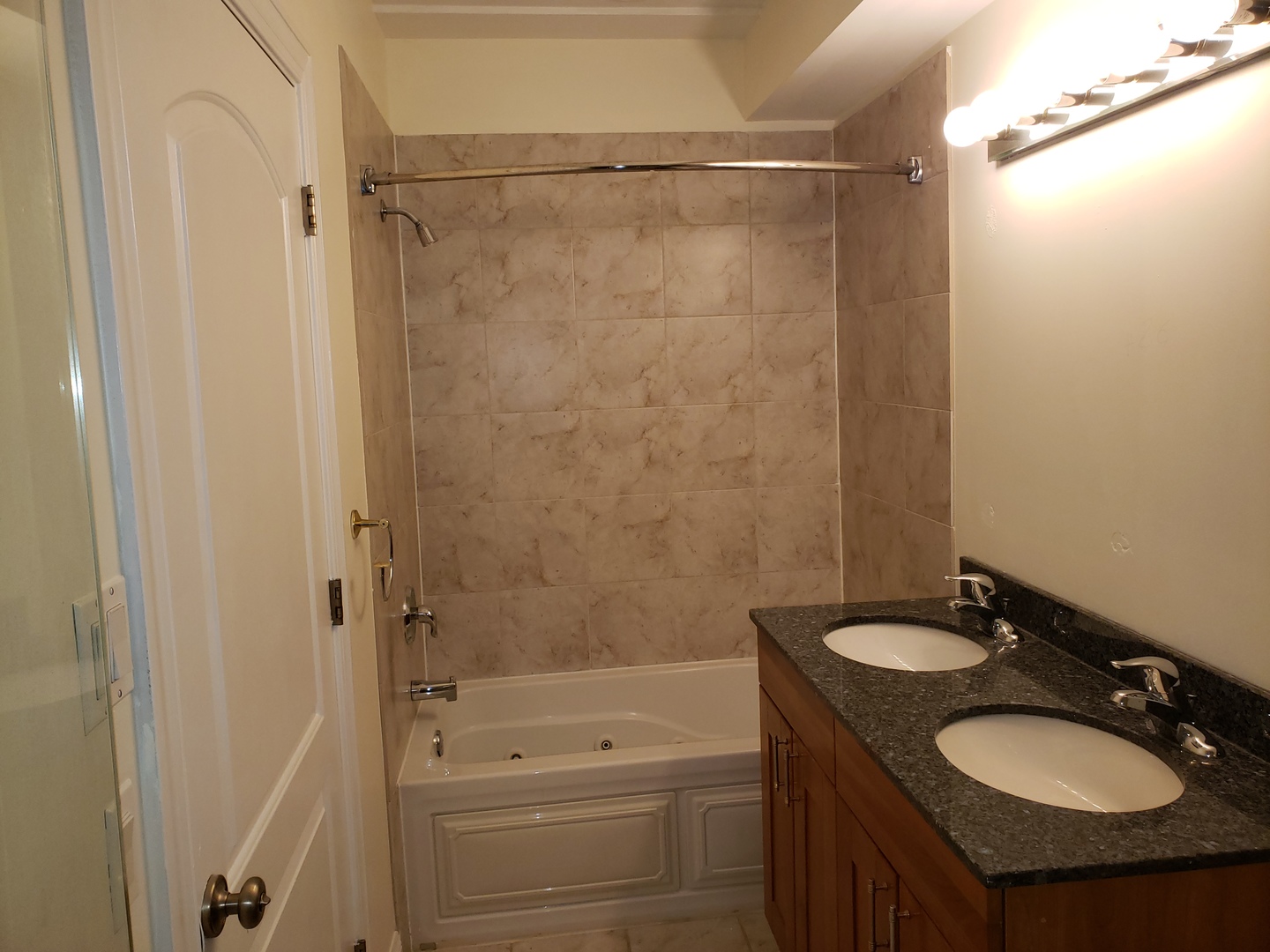 27 East 26th Street, Unit 3 Chicago, IL 60616 - Photo 10 of 17 a bathroom with a granite countertop sink toilet and shower