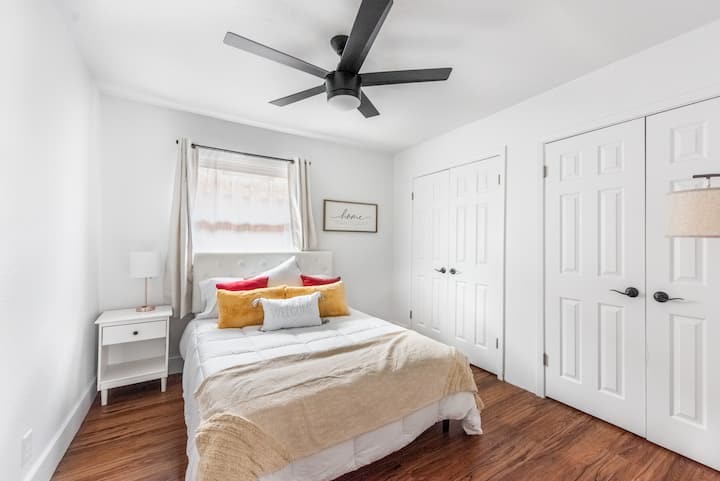 5700 Signal Point Austin, TX 78724 - Photo 14 of 16 Bedroom featuring multiple closets, wood finished floors, and a ceiling fan