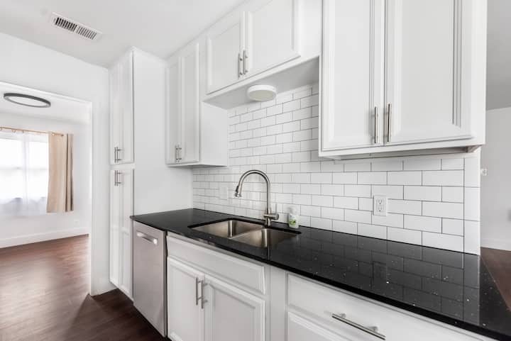 5700 Signal Point Austin, TX 78724 - Photo 6 of 16 Kitchen featuring dishwasher, white cabinets, and decorative backsplash