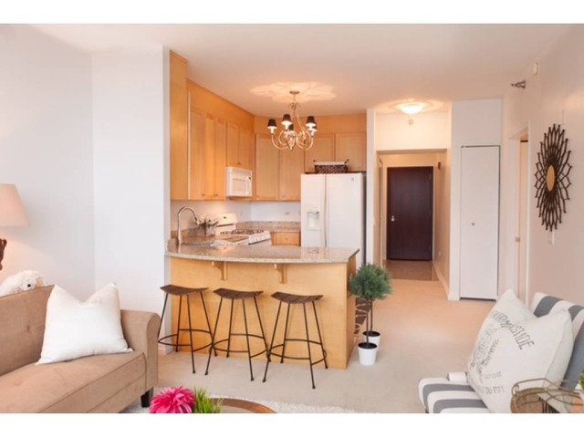 33 West Ontario Street, Unit 36G Chicago, IL 60654 - Photo 2 of 13 a living room with stainless steel appliances kitchen island granite countertop furniture and a view of kitchen