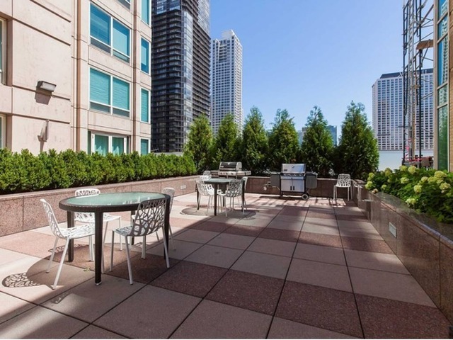 33 West Ontario Street, Unit 36G Chicago, IL 60654 - Photo 12 of 13 a view of a patio with table and chairs and potted plants