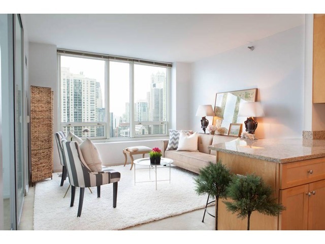 33 West Ontario Street, Unit 36G Chicago, IL 60654 - Photo 3 of 13 a living room with furniture and a large window