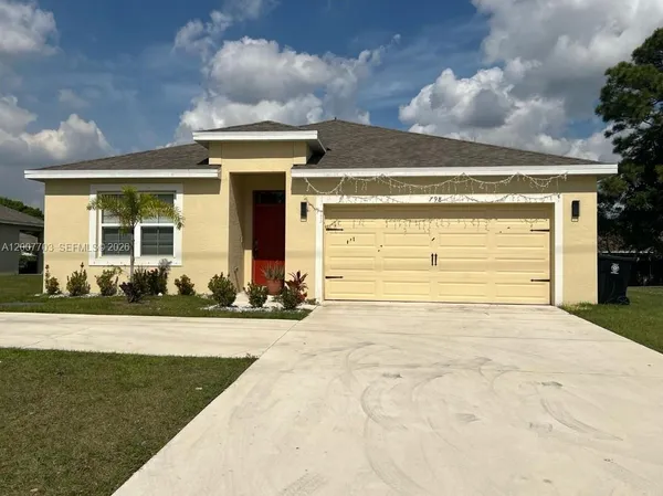 a view of a house with a yard and garage