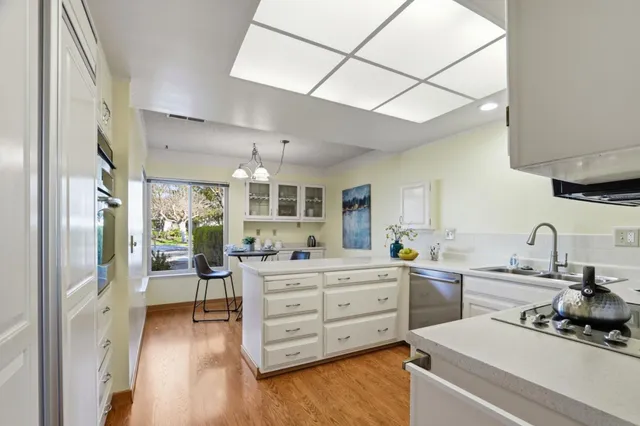 a kitchen with a sink stove and cabinets