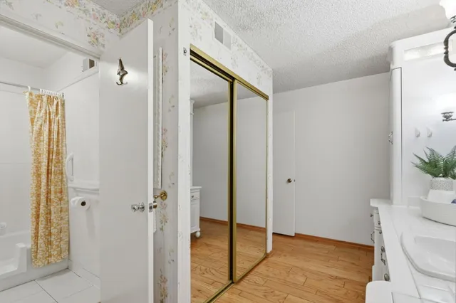 a bathroom with a glass shower door and a toilet
