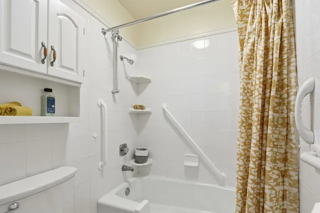 a bathroom with a shower curtain and a sink