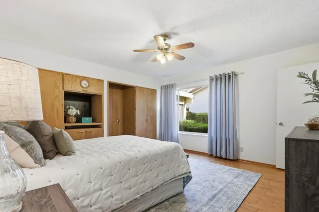 a bedroom with a large bed and a chandelier