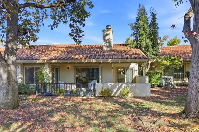 a view of a house with backyard porch and sitting area