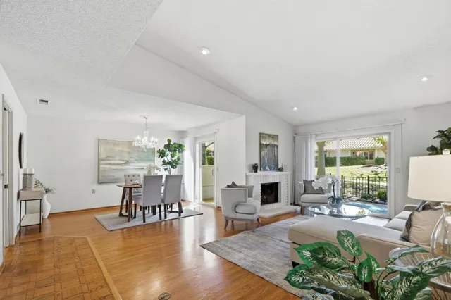 a living room with furniture large window and a table