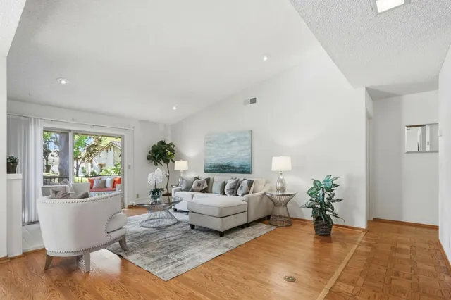 a living room with furniture and a potted plant