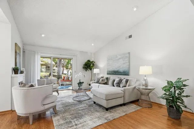 a living room with furniture and a potted plant