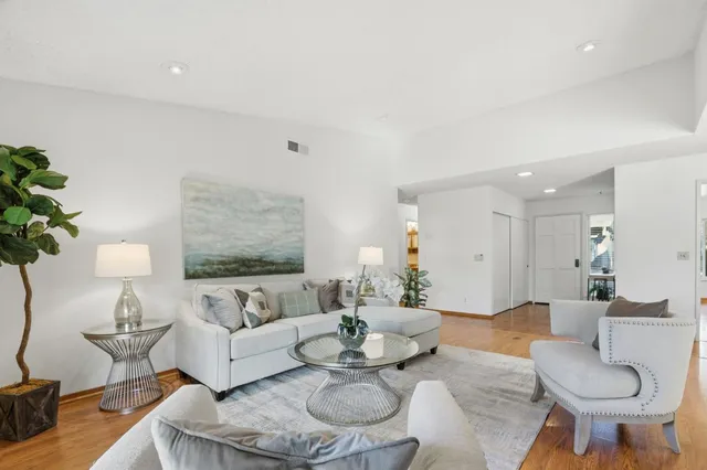 a living room with furniture a rug and a lamp