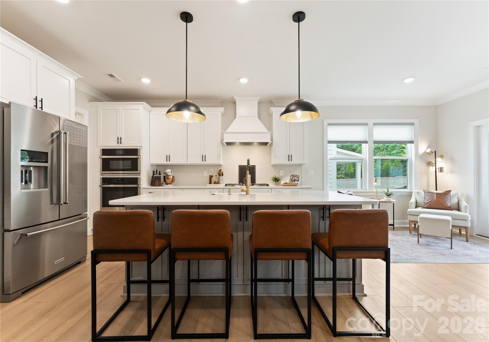 a dinning area with furniture a window and kitchen view
