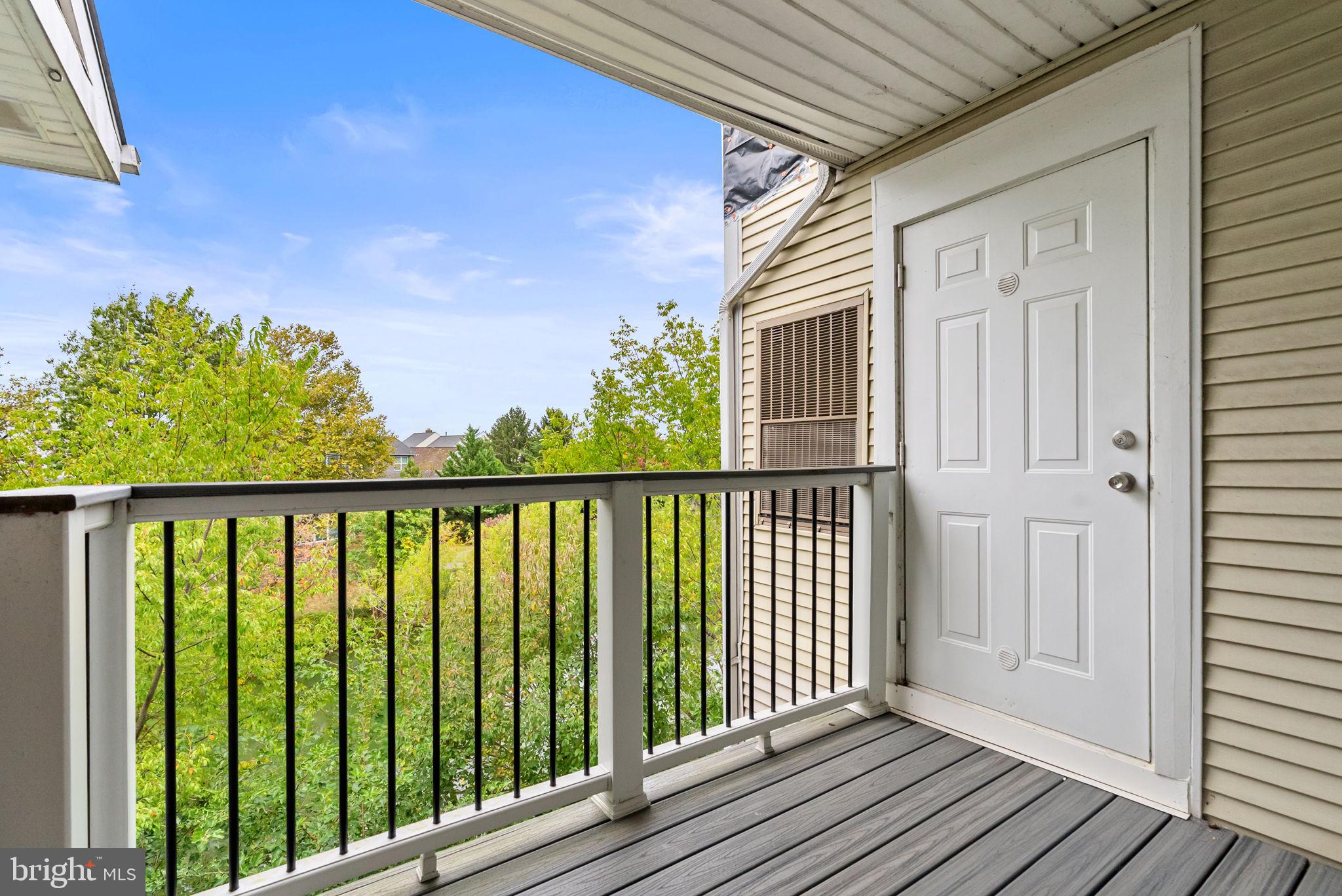 44084 Natalie Terrace, Unit 301 Ashburn, VA 20147 - Photo 16 of 59 a balcony with wooden floor