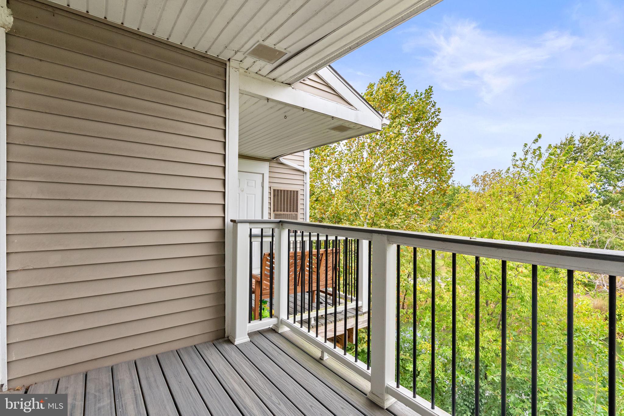 44084 Natalie Terrace, Unit 301 Ashburn, VA 20147 - Photo 17 of 59 a view of a balcony with a swing