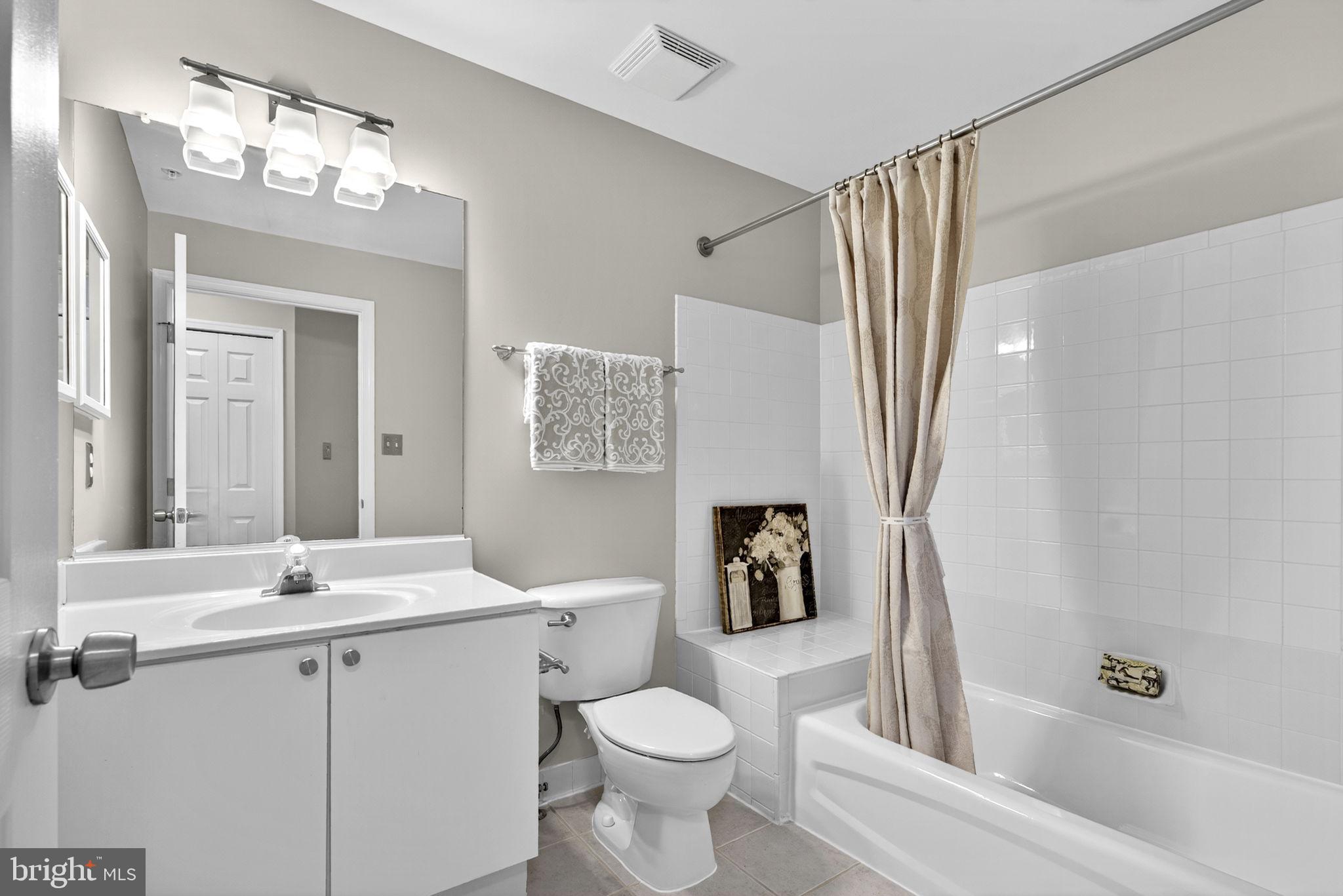 44084 Natalie Terrace, Unit 301 Ashburn, VA 20147 - Photo 22 of 59 a bathroom with a sink toilet and shower