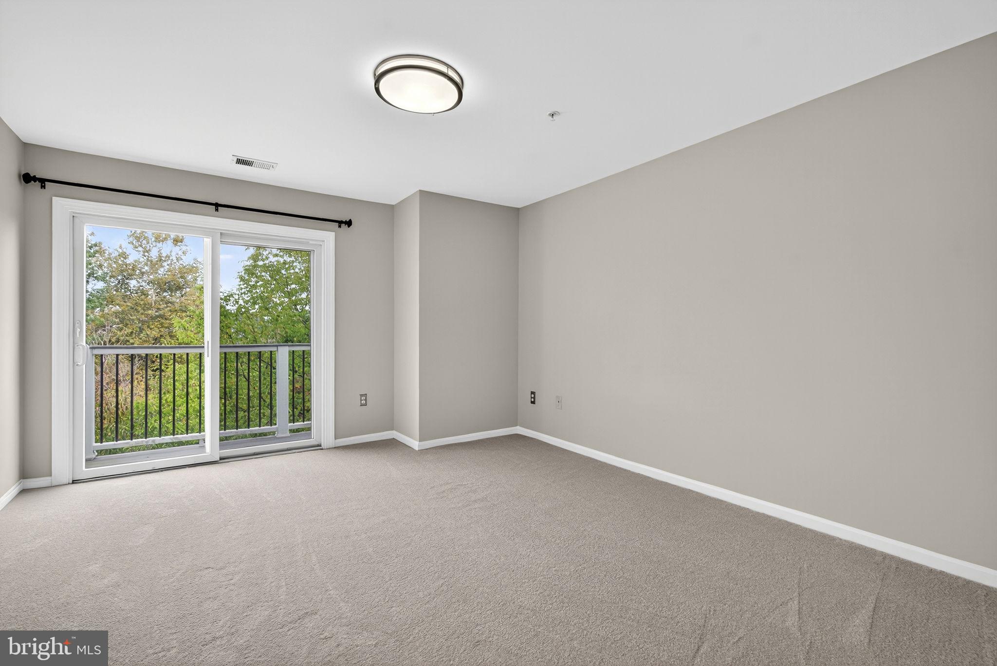 44084 Natalie Terrace, Unit 301 Ashburn, VA 20147 - Photo 25 of 59 a view of an empty room with a large window