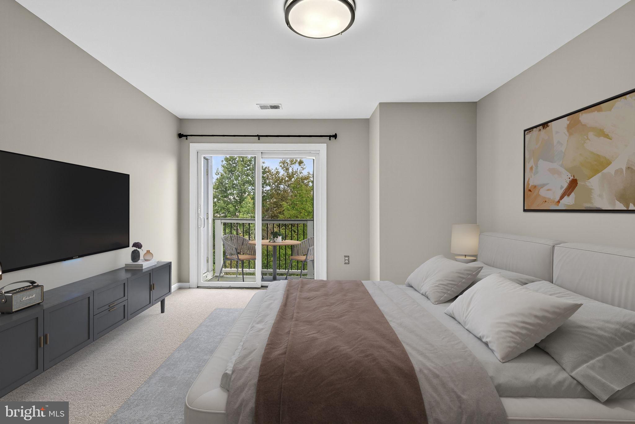 44084 Natalie Terrace, Unit 301 Ashburn, VA 20147 - Photo 27 of 59 a bedroom with a bed and a flat screen television