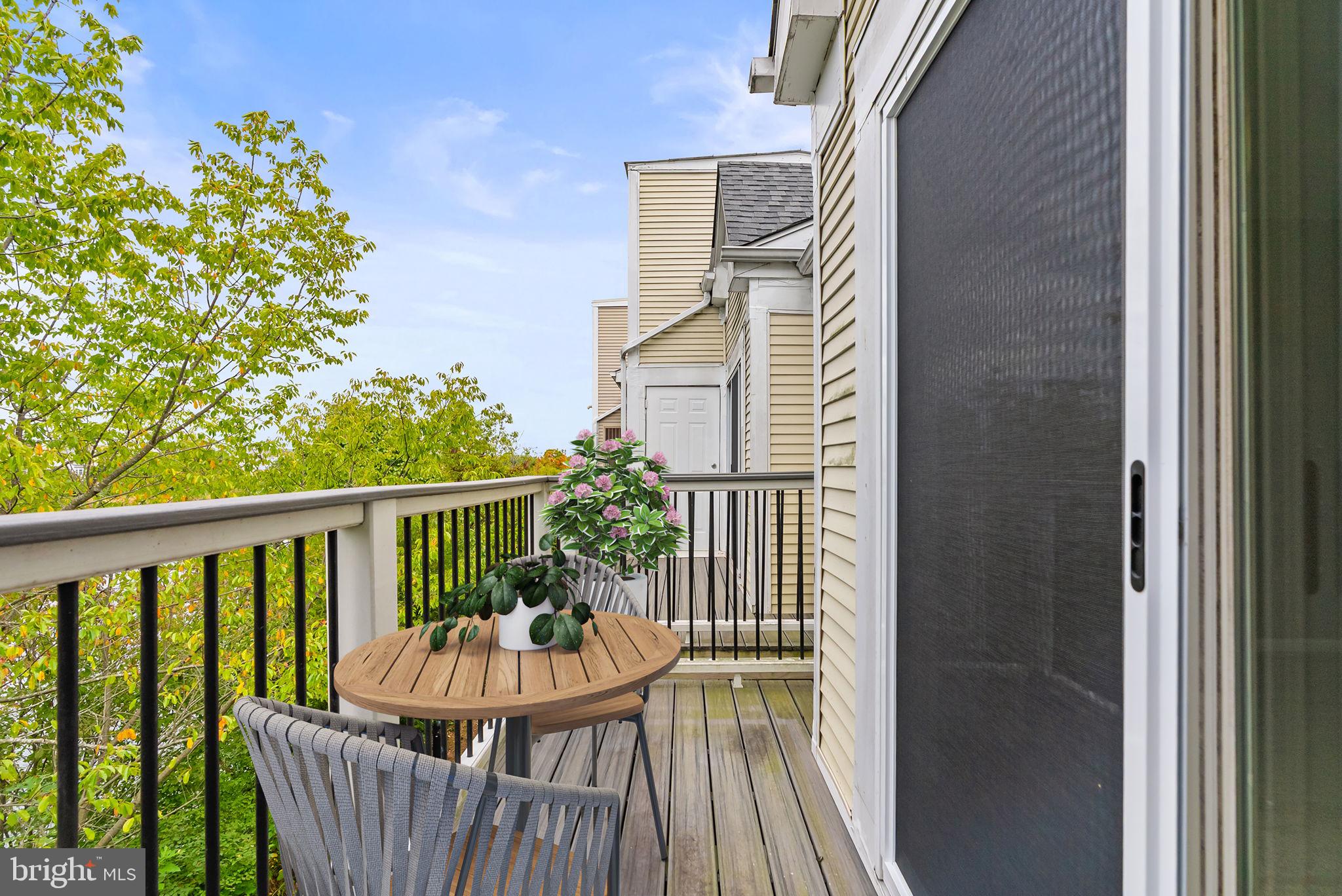 44084 Natalie Terrace, Unit 301 Ashburn, VA 20147 - Photo 29 of 59 a view of balcony with furniture and wooden floor
