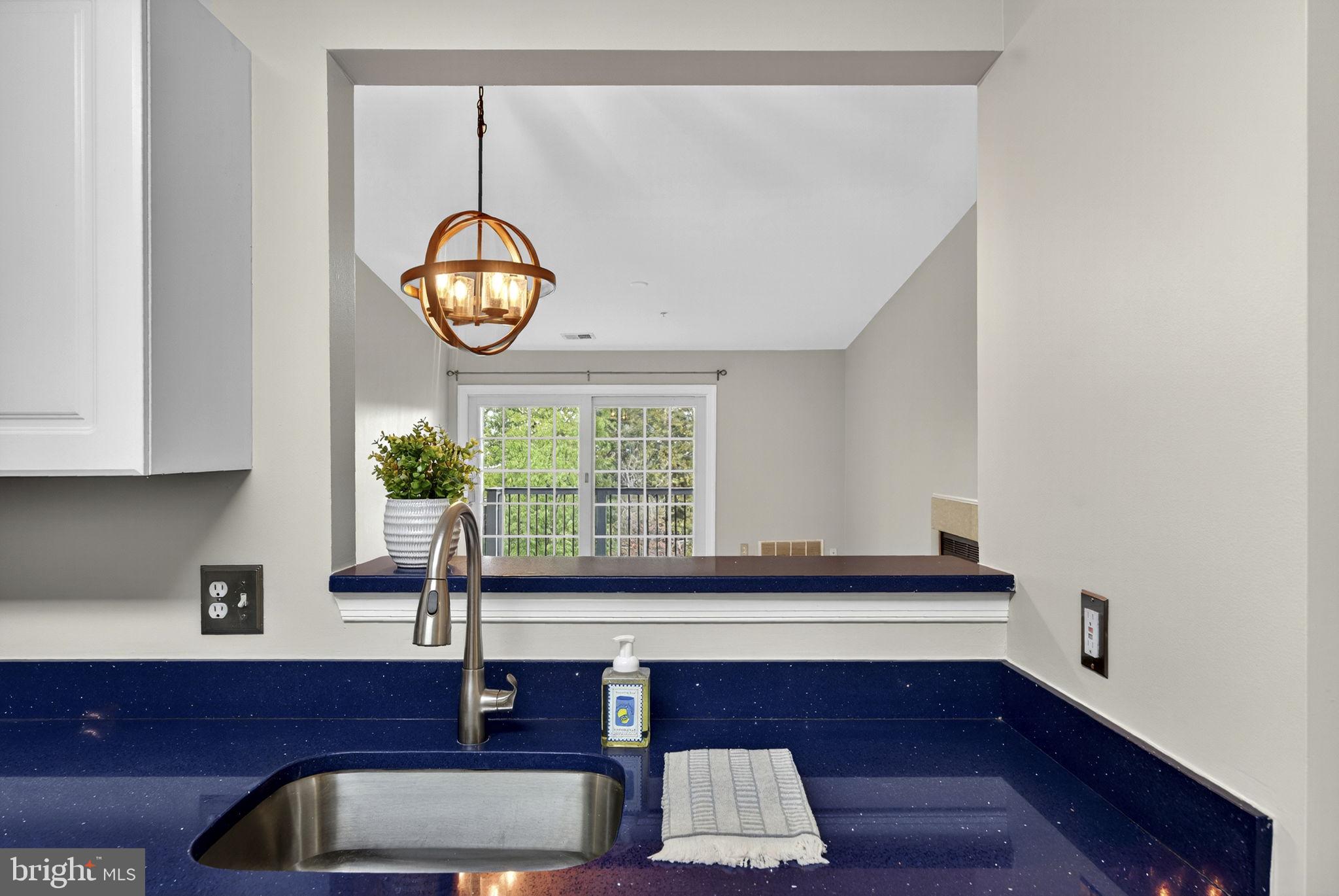 44084 Natalie Terrace, Unit 301 Ashburn, VA 20147 - Photo 36 of 59 a living room with furniture and a potted plant