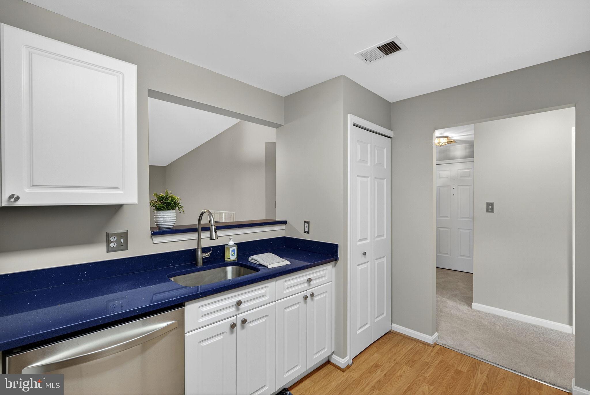 44084 Natalie Terrace, Unit 301 Ashburn, VA 20147 - Photo 37 of 59 a kitchen with a sink and cabinets