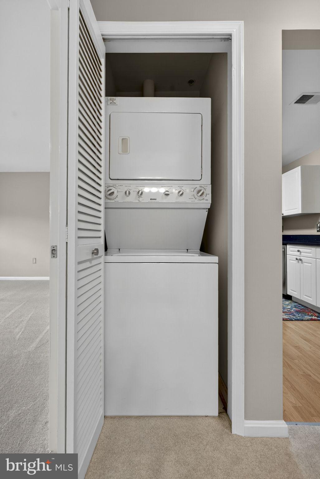 44084 Natalie Terrace, Unit 301 Ashburn, VA 20147 - Photo 41 of 59 a utility room with a washer and dryer