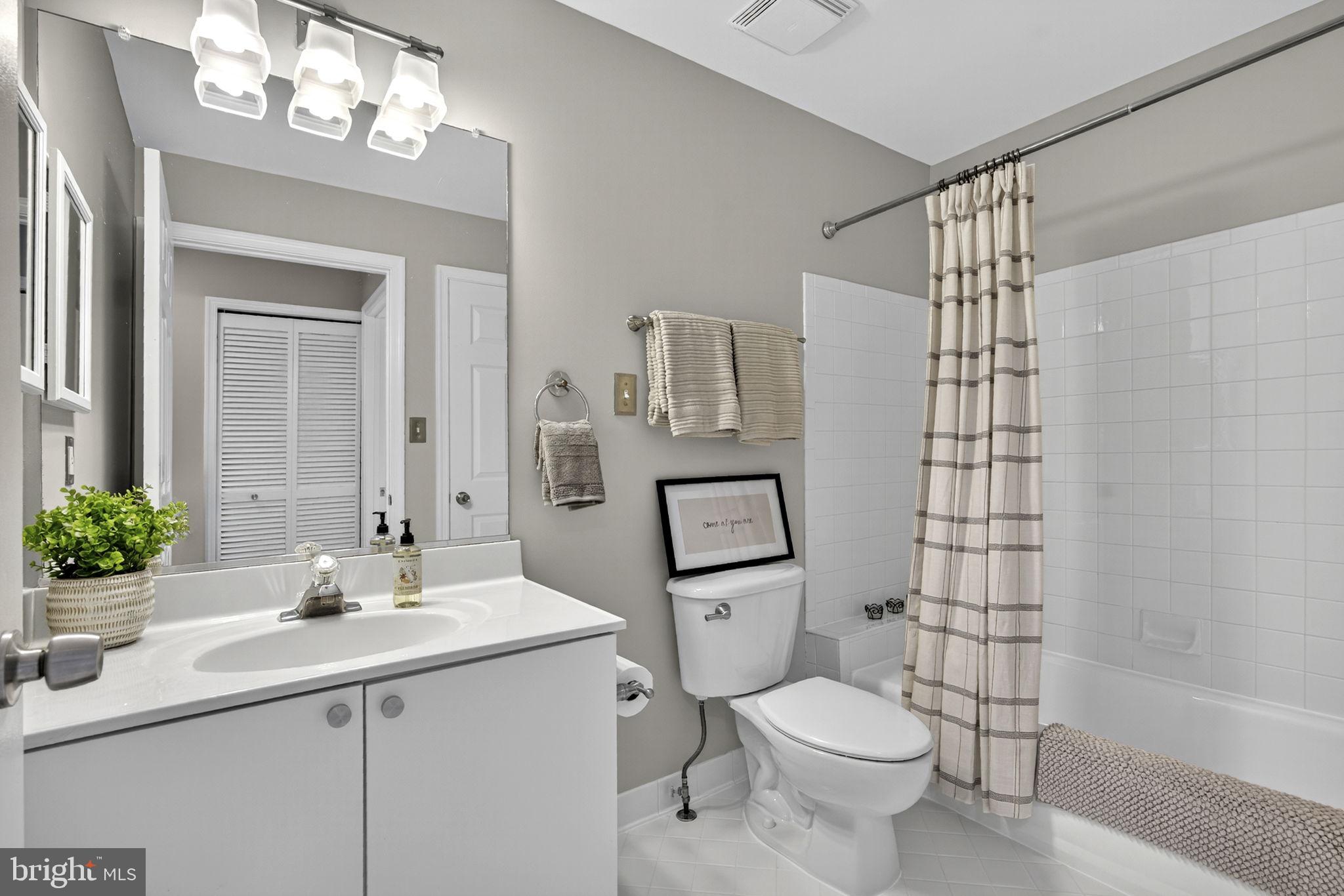 44084 Natalie Terrace, Unit 301 Ashburn, VA 20147 - Photo 42 of 59 a bathroom with a sink toilet and shower