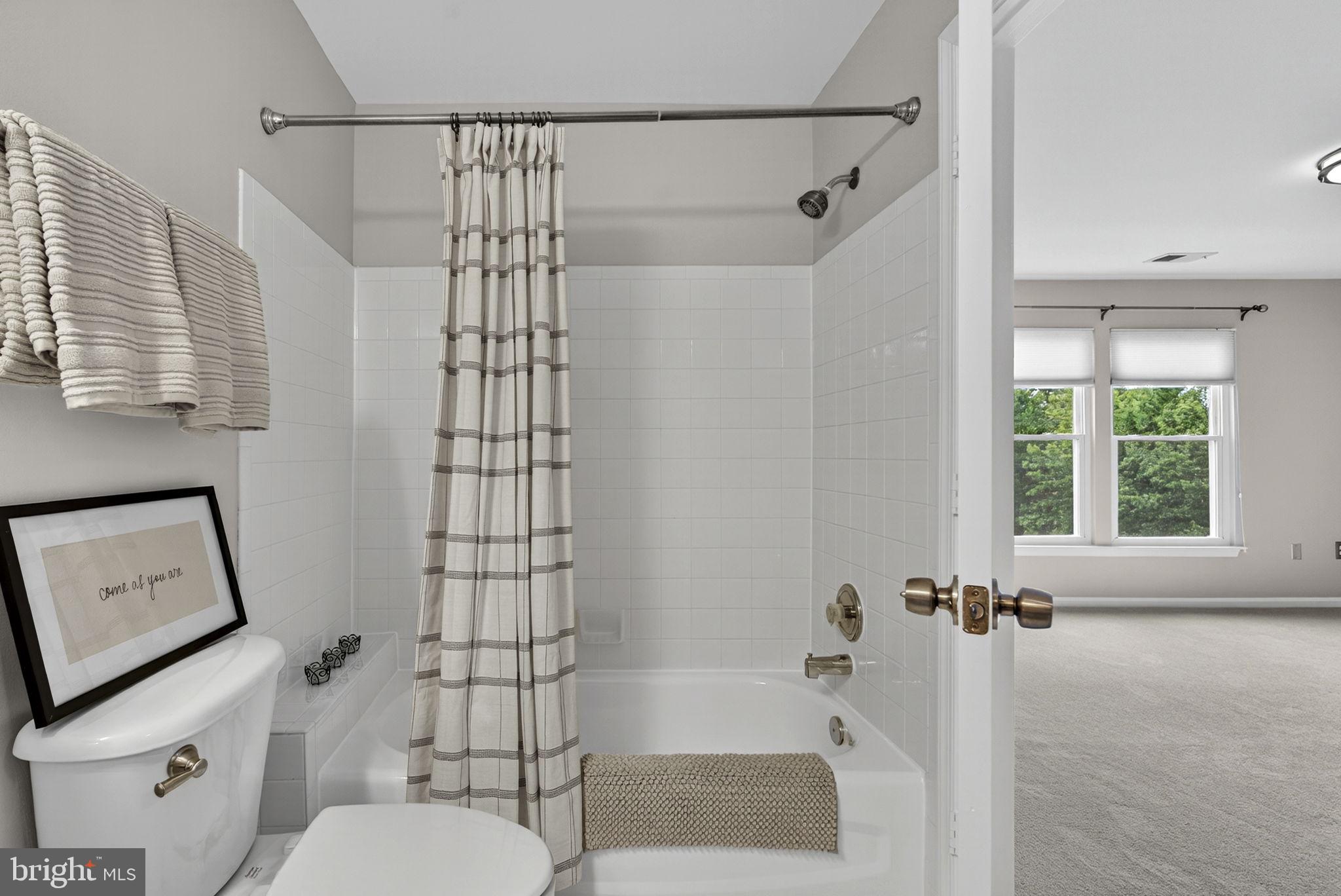 44084 Natalie Terrace, Unit 301 Ashburn, VA 20147 - Photo 43 of 59 a bathroom with a shower toilet and sink