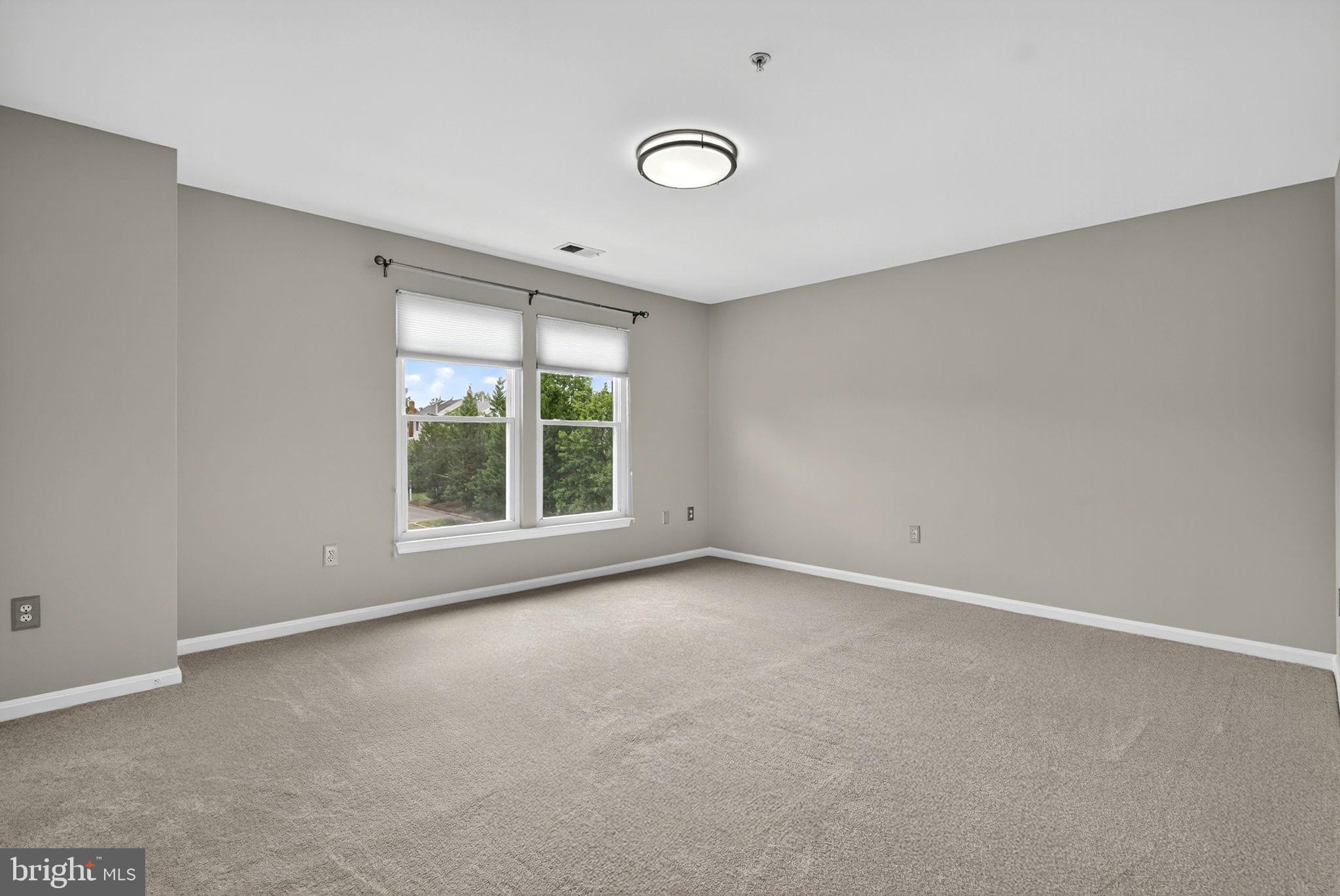 44084 Natalie Terrace, Unit 301 Ashburn, VA 20147 - Photo 45 of 59 wooden floor in an empty room with a window