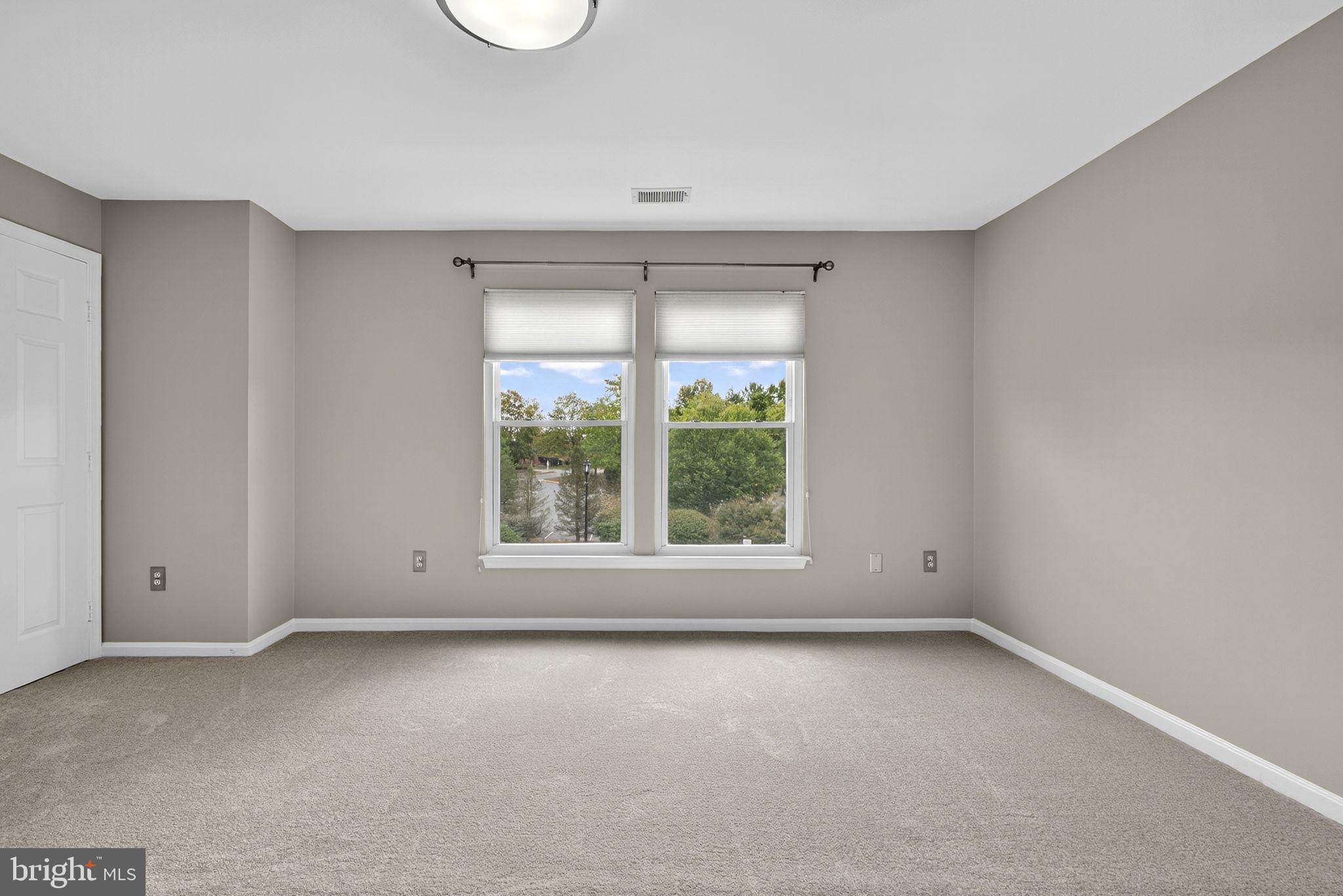 44084 Natalie Terrace, Unit 301 Ashburn, VA 20147 - Photo 47 of 59 an empty room with a window