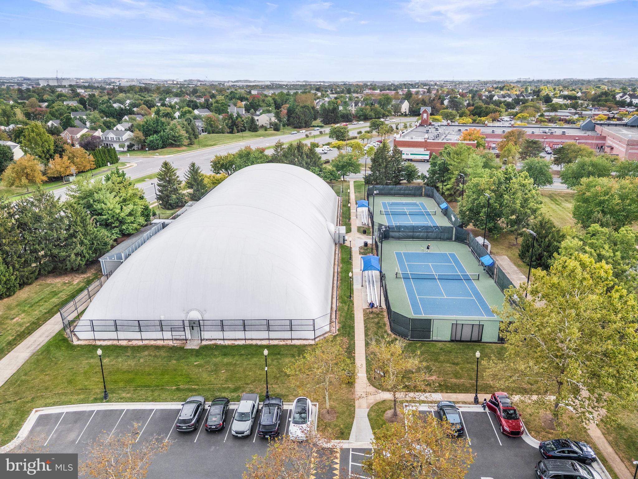 44084 Natalie Terrace, Unit 301 Ashburn, VA 20147 - Photo 54 of 59 an aerial view of a house with a garden and lake view
