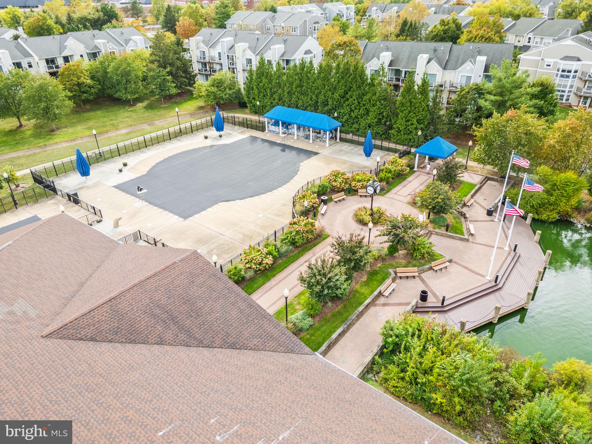 44084 Natalie Terrace, Unit 301 Ashburn, VA 20147 - Photo 56 of 59 an aerial view of a house with a yard and lake view