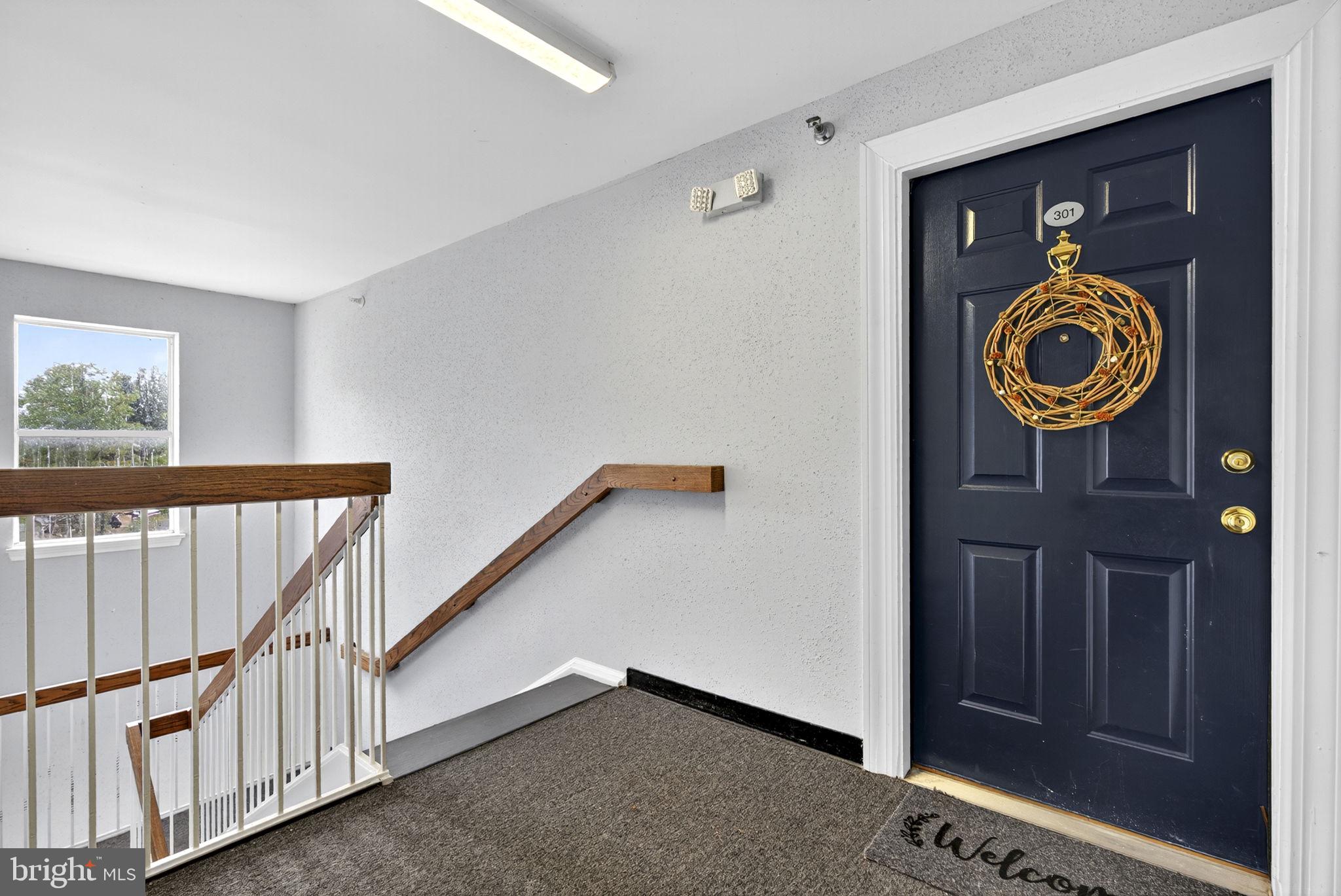 44084 Natalie Terrace, Unit 301 Ashburn, VA 20147 - Photo 8 of 59 a view of an entryway with wooden floor
