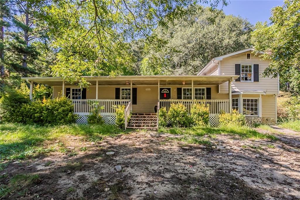 a view of house with backyard and garden